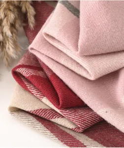Soft cashmere-feel plaid winter scarf detail showing texture and warm fabric.