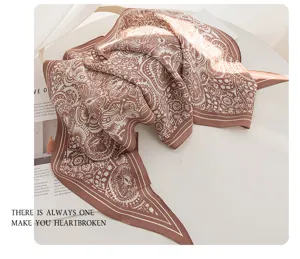 Silk scarf detailed view featuring elegant brown vintage floral pattern design and soft texture