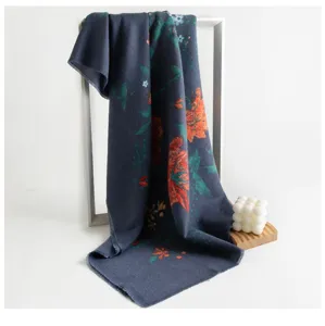 Detail view of women's imitation cashmere scarf with ethnic floral print and stylish tassels.
