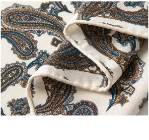 Close-up view of luxury silk wool scarf with exquisite paisley print and soft fabric texture.