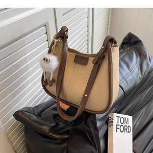 Chic two-tone hobo shoulder bag with cute fluffy plush pendant, stylish daily tote purse.