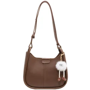 Stylish brown leather underarm shoulder bag for women, chic autumn winter fashion handbag.