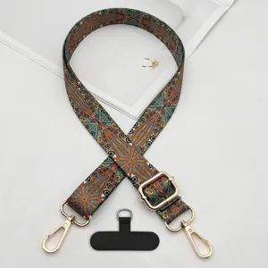 Bohemian style adjustable phone strap with golden metal hooks and universal tether patch detail.
