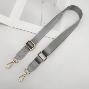 Verstelbare grijze nylon vervangende schouderriem met gouden metalen hardware voor handtassen.
