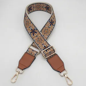 Detailed shot of ethnic embroidered wide bag strap, adjustable replacement crossbody strap.