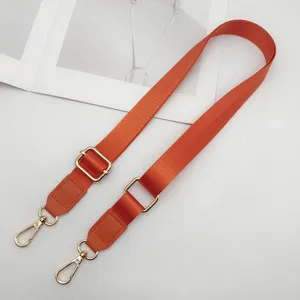 Verstelbare oranje nylon vervangende tasriem met PU lederen uiteinden en gouden metalen clips.