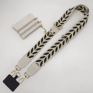 Wide embroidered bag strap replacement with detachable coin purse and phone tether connector.