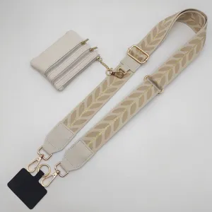 Wide embroidered bag strap with leaf pattern, detachable coin pouch and phone tether for crossbody bags.