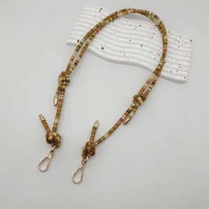 Colorful woven strap replacement for bags and phones, ethnic style with gold metal clasps.