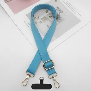 Correa de repuesto azul para teléfono con herrajes de metal dorado y pestaña de sujeción.