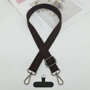 Correa ajustable marrón oscuro cruzada para teléfono móvil con hebillas y lengüeta fijación.