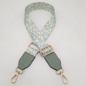 Adjustable replacement bag strap with trendy abstract print, gold metal hardware, and PU leather ends.