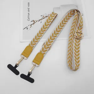 Lanière de téléphone portable à motif de feuilles avec connecteurs en cuir et boucle réglable.