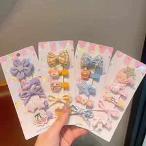 Cute kids hair clips set with bows and floral designs, perfect sweet styling accessories for girls.