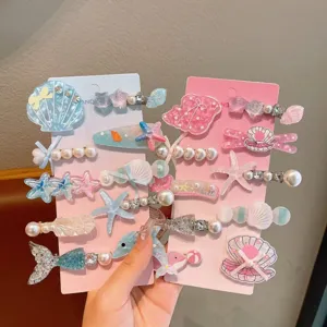 Cute children hairpin set featuring mermaid tails, seashells and pearls for girl hair styling.