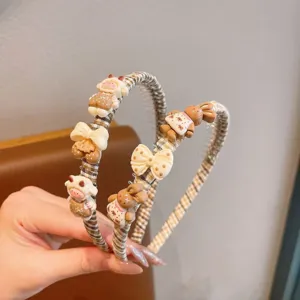 Vue détaillée du serre-tête antidérapant pour enfants avec de jolis charms d'animaux et nœuds.