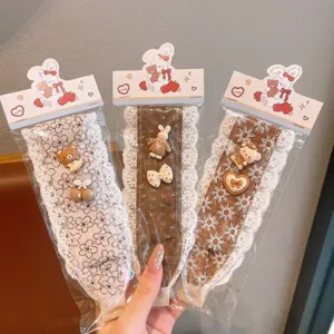 Cute lace hair bands with sweet cartoon bear and rabbit charms, detail shot of hair accessories.