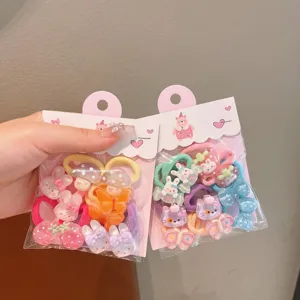 Close-up detail of cute cartoon hair ties set, colorful elastic bands and resin charms for kids.