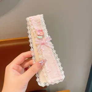 Close up detail of pink lace floral bangs sticker featuring cute bow and resin flower decor.