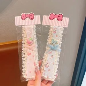 Close-up detail of cute lace hair bands with sweet strawberry and rabbit charms.
