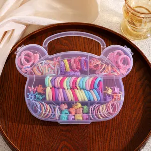 Cute bear shaped storage box detail, filled with colorful elastic hair ties and mini claw clips.