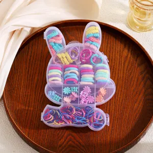 Detailed view of the cute bunny-shaped storage box filled with colorful mini hair ties and clips.