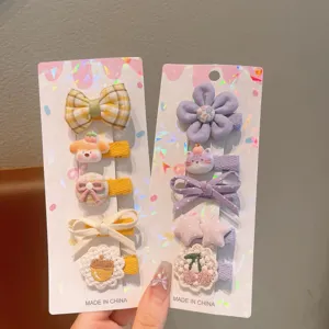 Close-up details of cute children hair clip set with adorable bows and floral accessories.
