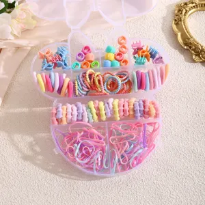 Close-up detail of assorted colorful mini hair ties and clips inside a cute storage case.