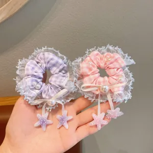 Close-up detail of Korean plaid lace hair scrunchies with sweet pearls and cute star charms.
