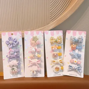 Detailed view of colorful children hair clips set featuring cute cartoon designs and bows.