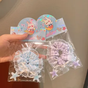 Detail view of cute Korean style plaid lace hair scrunchies with pearls and star pendants.