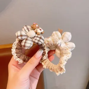 Plaid fabric hair scrunchies with cute lace edge floral design and small bear pendant accessory.