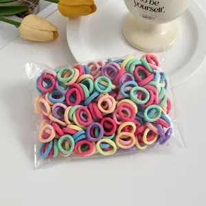 Colorful mini hair ties detail view, seamless elastic bands for kids hair styling accessories.