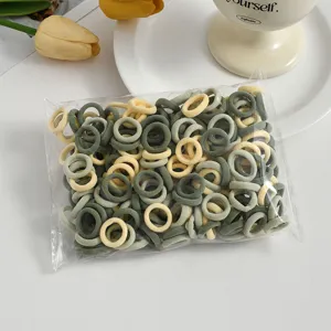 Detailed view of mini elastic hair ties, seamless toddler towel rings in mixed soft colors.