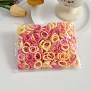 Detailed view of colorful seamless mini hair ties for kids, soft elastic small towel hair bands.
