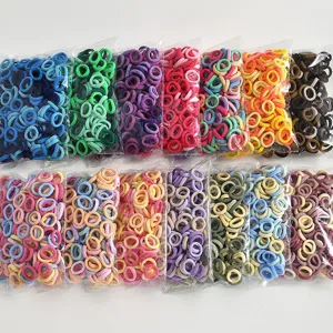Detailed view of colorful mini elastic hair ties in transparent bags, assorted colors.