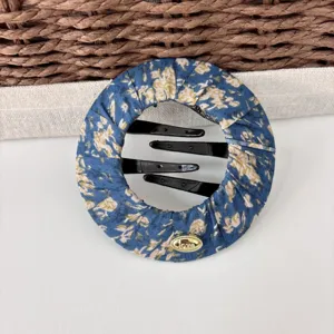 Blue floral fabric hair bun maker clip with black plastic combs and cute metal love charm decoration.