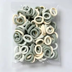 Detailed view of assorted color elastic hair ties for kids, soft and high stretch bands.