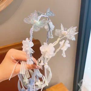 Kids fairy flower headband with butterfly mesh, pearls and long ribbons for stage performance.
