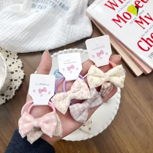 Deliziosi elastici per capelli da bambina con fiocchi floreali e a quadri, stile dolce.