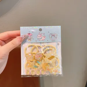 Detail view of cute cartoon kids hair ties set with resin star and bow charms, elastic bands.