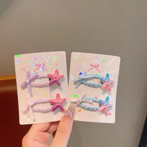 Detailed shot of colorful children hair clips with cute starfish and bow designs on display cards.