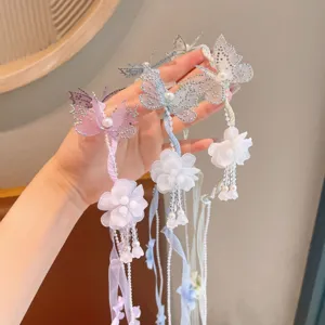 Detailed view of fairy butterfly flower hair accessories with pearls and long crystal tassels.