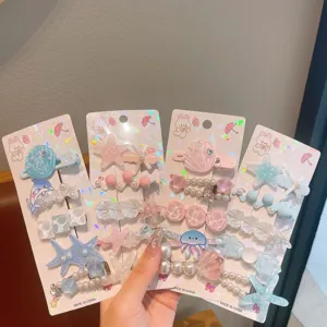 Close-up detail of cute summer ocean theme hair clips with starfish, shells, and pearls.
