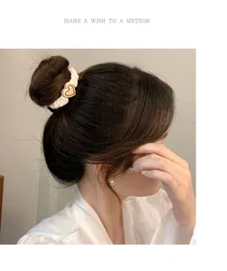 Elegant heart scrunchie detail shot, soft fabric and cute charm for daily stylish hair styling.
