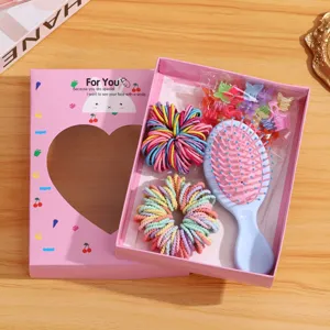 Kids hair accessories gift box set detail showing colorful hair ties, clips, and cute hair brush.
