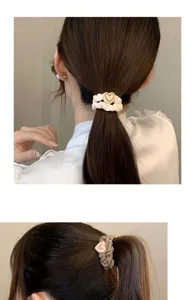 Detailed view of cute heart scrunchie ponytail holder, soft fabric hair accessory for women.
