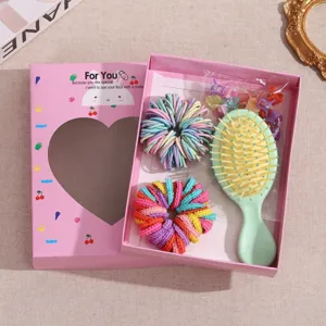 Kids hair accessories gift set with colorful scrunchies, mini hair claws, and cute hair brush in box.