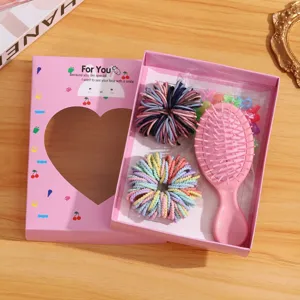 Detailed view of children hair accessory gift box with pink brush, colorful ties and mini clips.