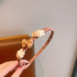 Joli serre-tête marron à pois avec nœud et lapin de dessin animé pour les enfants.